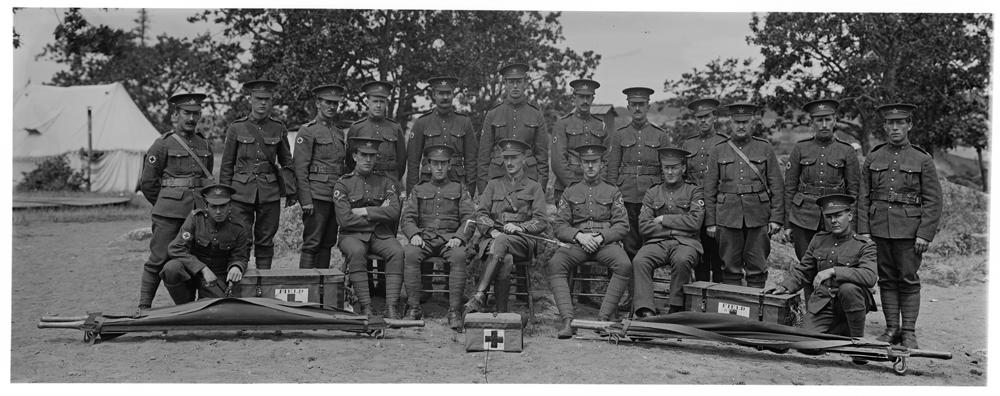 Photograph depicts Canadian Army Medical Corps soldiers attached to the 103rd Battalion (Vancouver Island Timber Wolves). They are posed here with equipment, including first aid kits and stretchers.